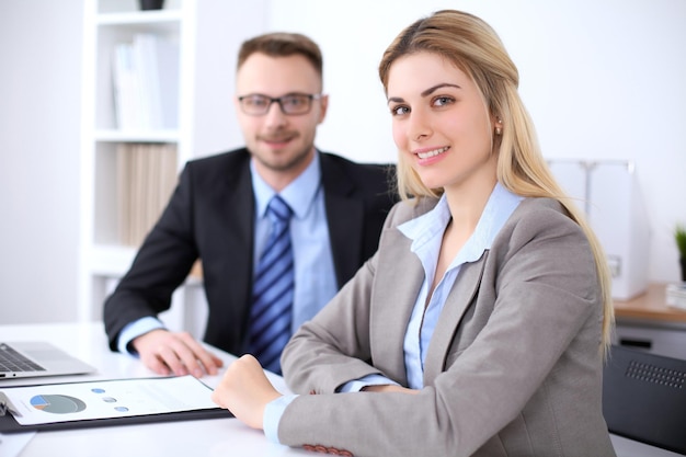 Two successful business partners working at meeting in office Focus on blonde