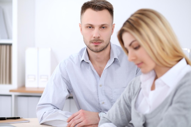 Two successful business partners working at meeting in office. Focus on man