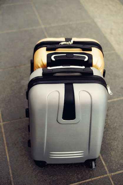 Two suitcases on grey blurred floor