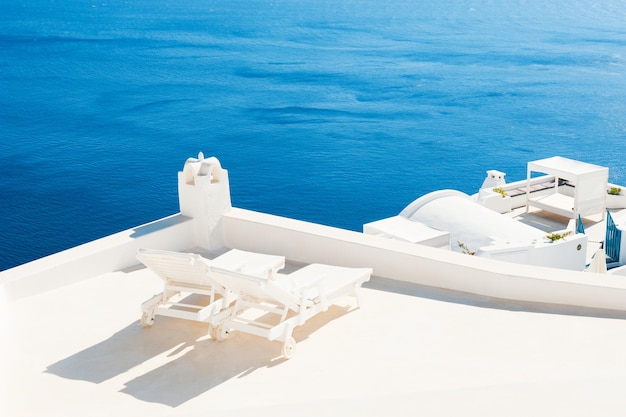 Two sunbeds on the terrace. Santorini island, Greece. Travel and vacation