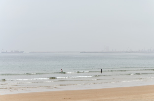 Two Surfers about to Ride the Waves