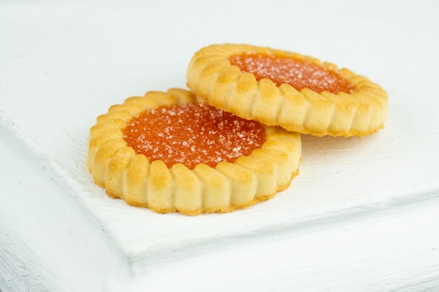 Two sweet biscuits with orange marmalade