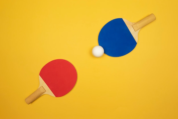 Two table tennis rackets lie opposite to each other ready for the ping-pong competitions