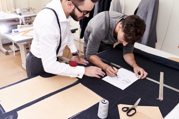 Two Tailors Working in Atelier