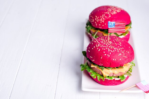 Two tasty hamburgers with little american flags