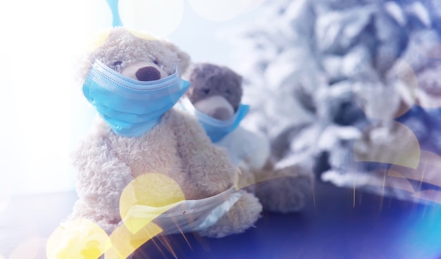 Two teddy bears wearing protective mask. Coronavirus protection. Toy bear in mask to prevent virus spread. Copy space.