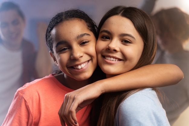 Two teenage girl posing together at home during party