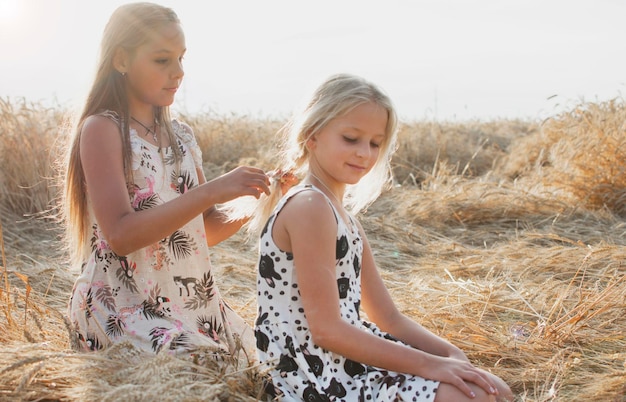 Two teenage girls in a spike field in summer