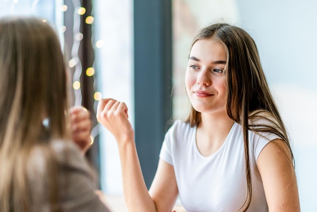 Two teens on meeting in cafe for chatting