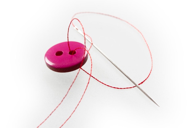 Two thread holes pink button needle and thread