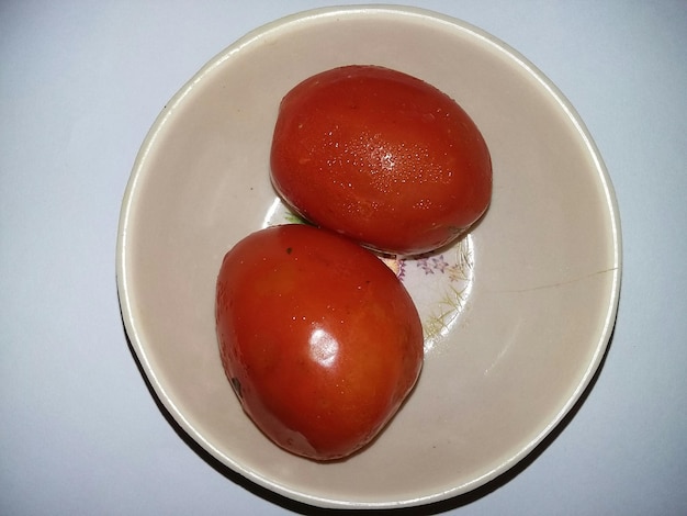 Two tomatoes in bowl