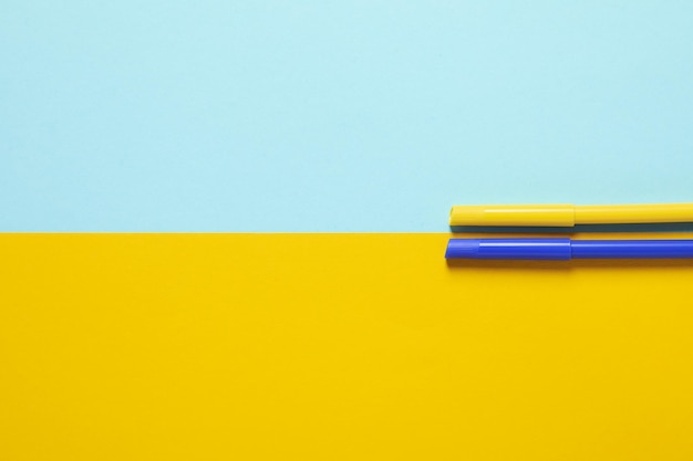 Two tone background in colors of Ukrainian flag with felttip pens