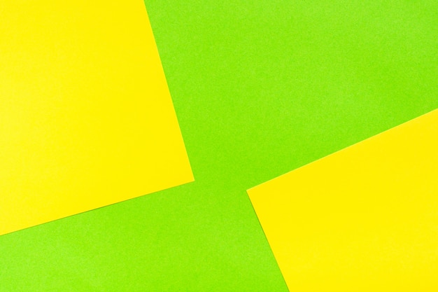 Two-tone yellow green abstract cardboard background. Sheets of cardboard are stacked on top of each other. 
