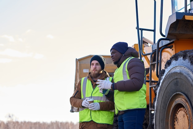 Two Tough Workers on Industrial Site Outdoors