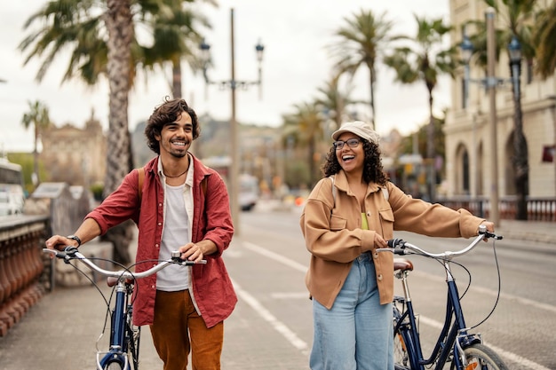 Two tourists are pushing bike in city