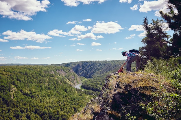 Two tourists climbed to the top with a view of the valley