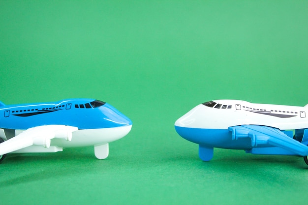 two toy airplanes overhead view with green background