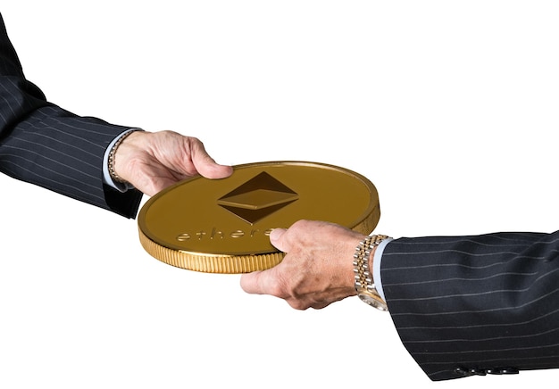 Two traders hands holding large Ethereum