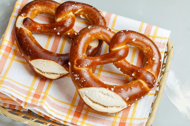 Two traditional soft Octoberfest pretzels in bread basket closeup