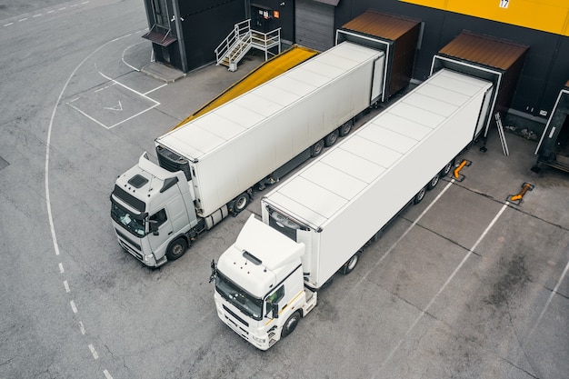 Photo two trucks loading in the distribution hub