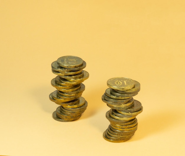 Two turrets made of coins Money on yellow background
