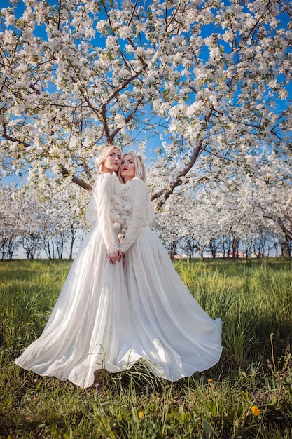 two twin sisters in a cherry orchard