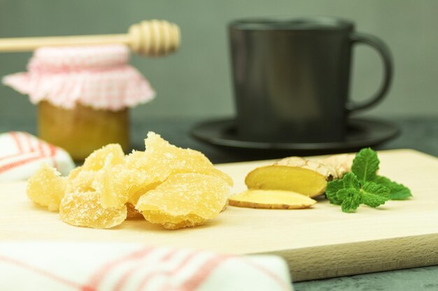 Two types of ginger fresh and candied on a rustic table