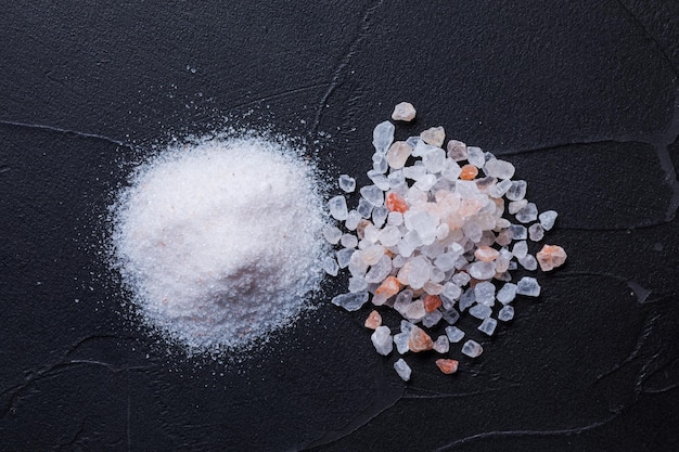 Two types of salt on black background