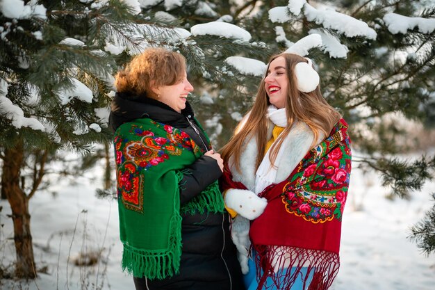 Two Ukrainian women with brightly colored traditional scarves Soon Ukraine will win the war