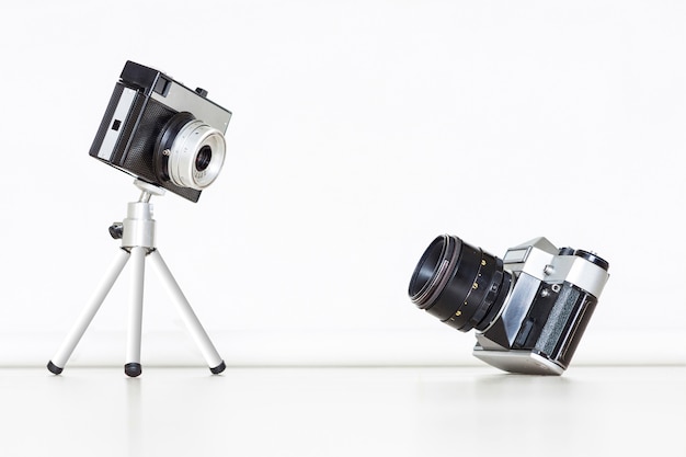 Two vintage old cameras together. Big and little concept.