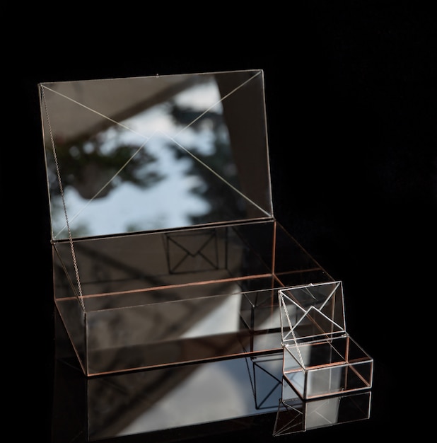 Photo two wedding jewerly glass boxes in the form of an envelope.