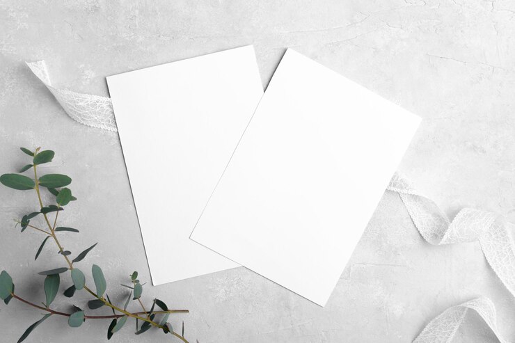 Photo two wedding stationery invitation cards mockup 5x7 on neutral grey marble background with eucalyptus leaves
