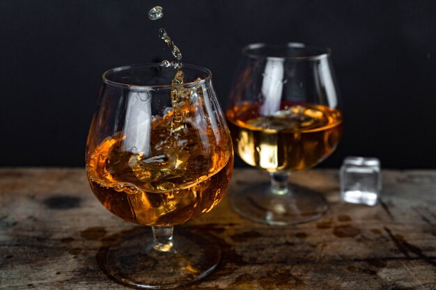 Two whiskey or cognac glasses with ice