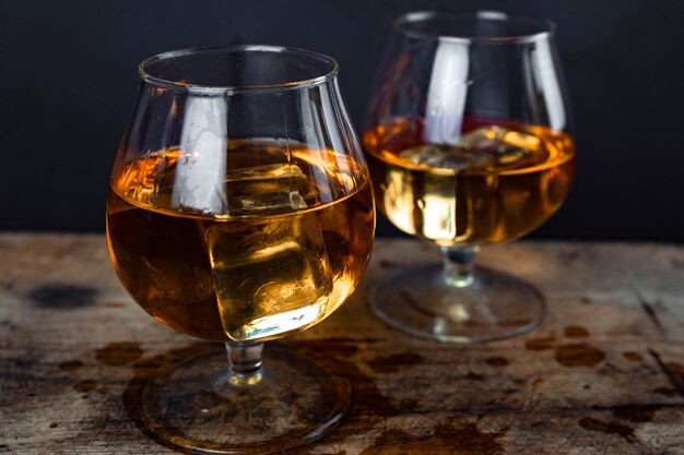 Two whiskey or cognac glasses with ice