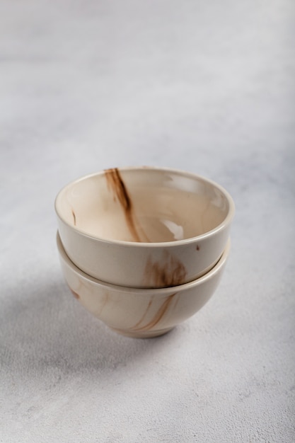 Two white clay bowls on a light background