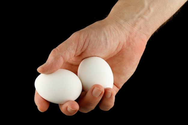 Two white eggs in hand closeup