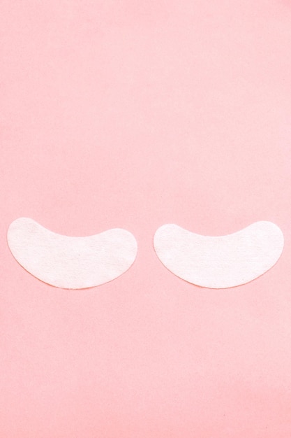 Two white patches on a pink background