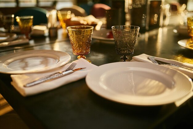 two white plates and two glasses on the table