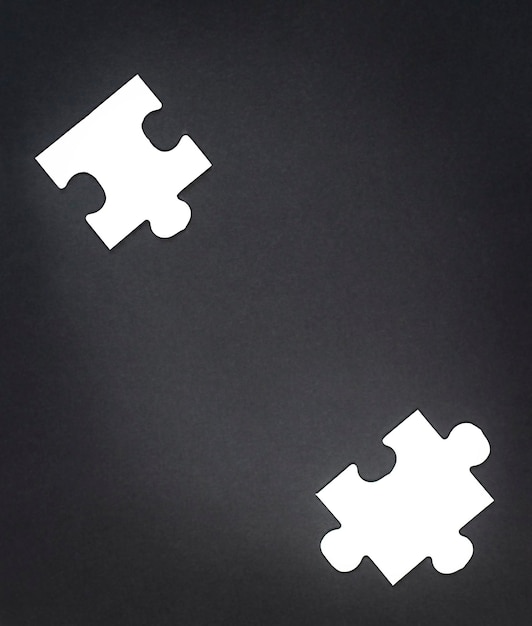 Two white puzzles on a black background