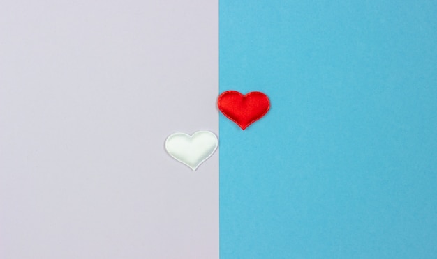 Two white and red hearts on two sides of the background. 