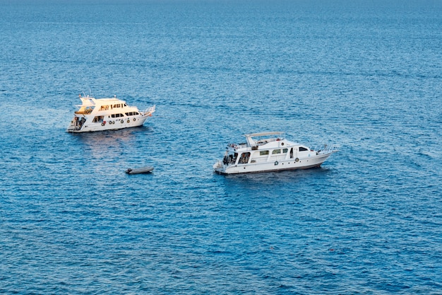 Two white ship in blue water of sea or ocean