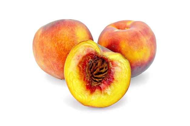 Two whole peach and one half peach isolated on white background