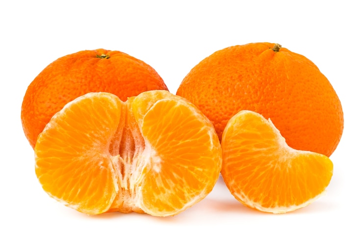 Photo two whole tangerines and peeled on white, isolated.