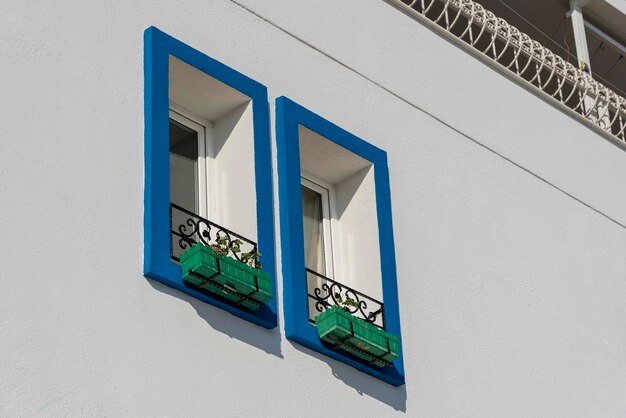 Two windows with flower pots on white wall Turkey copy space