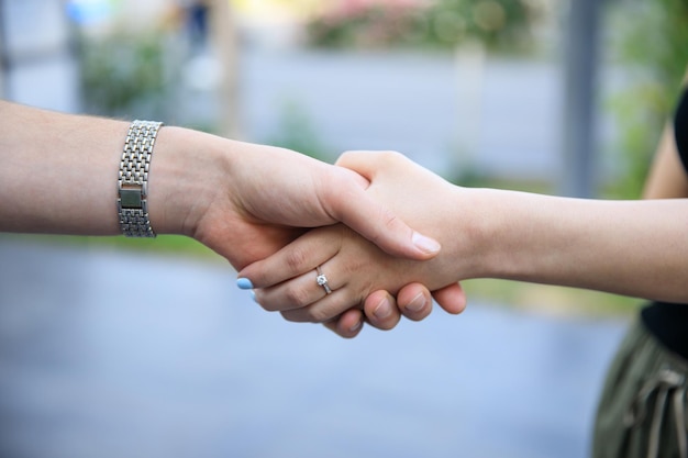 Two woman greet by hand