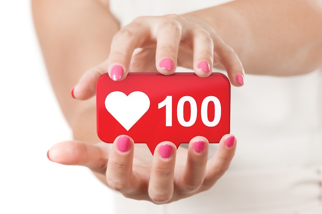 Two Woman Hands Protecting Red Social Media Network Love and Like Heart Icon on a white background. 3d Rendering