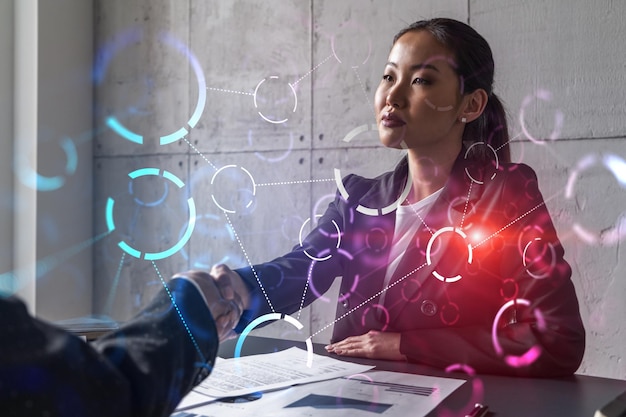 Two woman handshake abstract tech hologram multiexposure\
international business