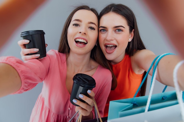 Two woman looking inside cardboard box