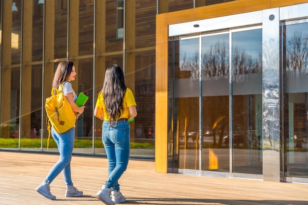 two woman walking along the university campus