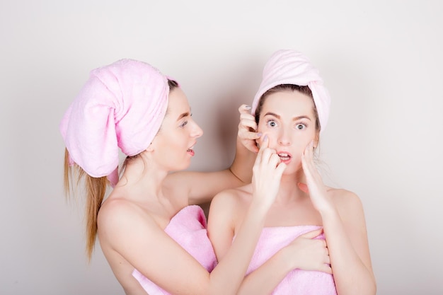 Two woman with a towel on her head